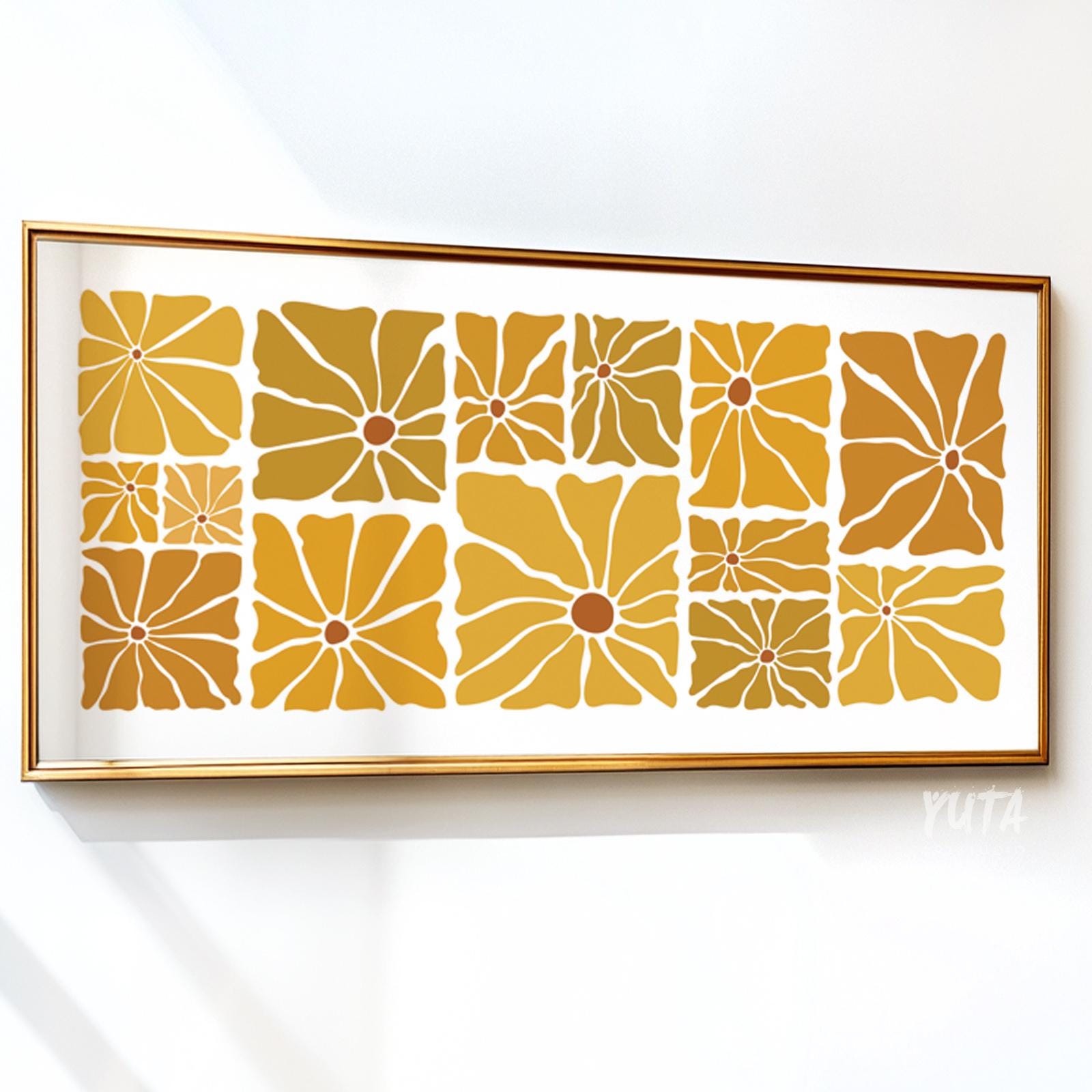 Geometric mid-century floral print in ochre and mustard, framed above a sofa.