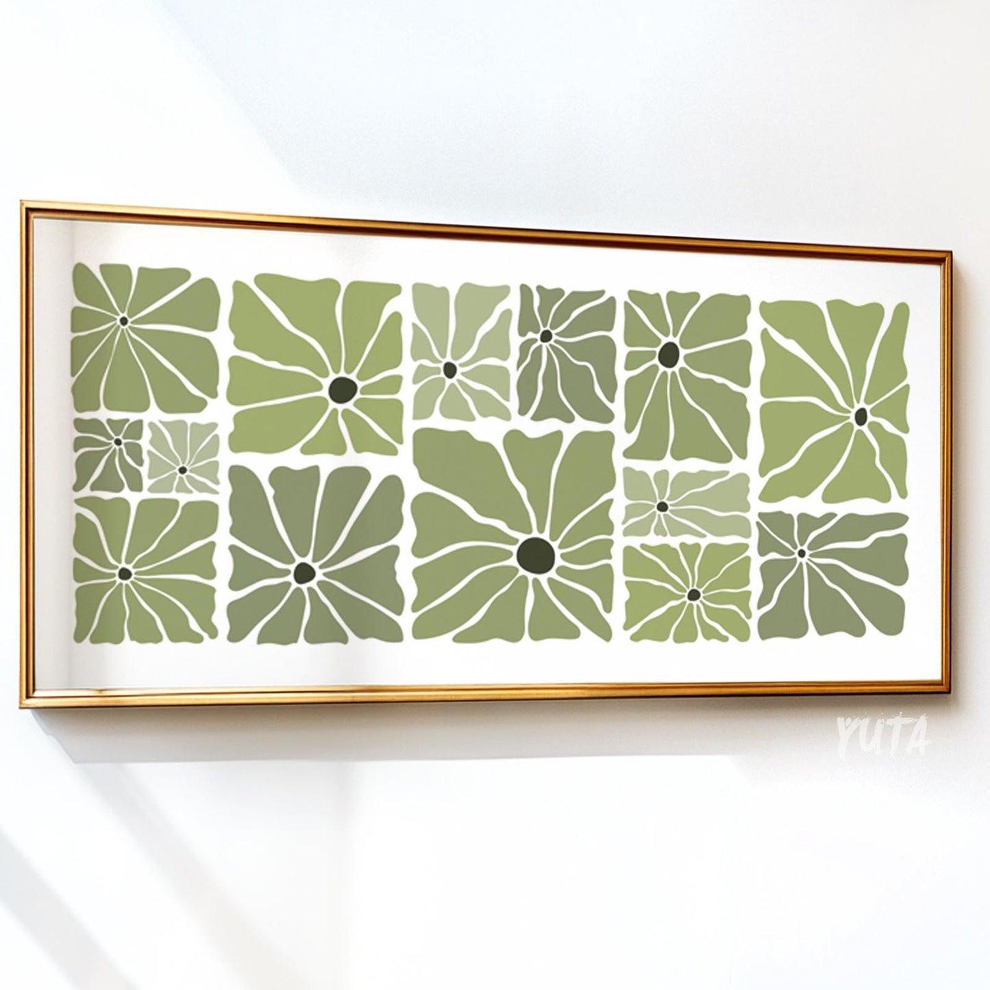Framed olive green floral print in mid-century modern style above a white cabinet