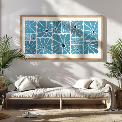 Large blue geometric floral print in light wood frame displayed above a low console bench