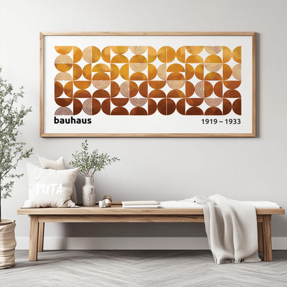 Framed Bauhaus-inspired geometric print in terracotta and mustard tones above a wooden bench