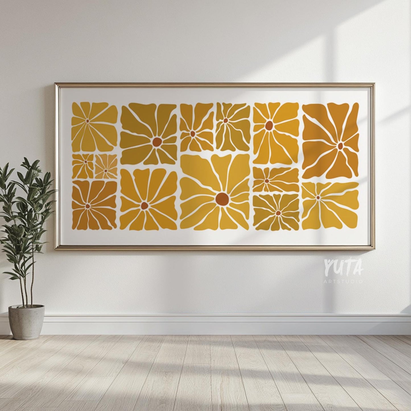 Large framed mid century floral print in mustard tones displayed in sunlight above wood floors