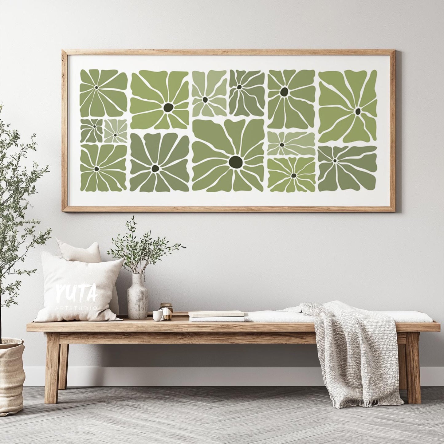 Large framed botanical print in olive green displayed above a wooden bench for scale reference