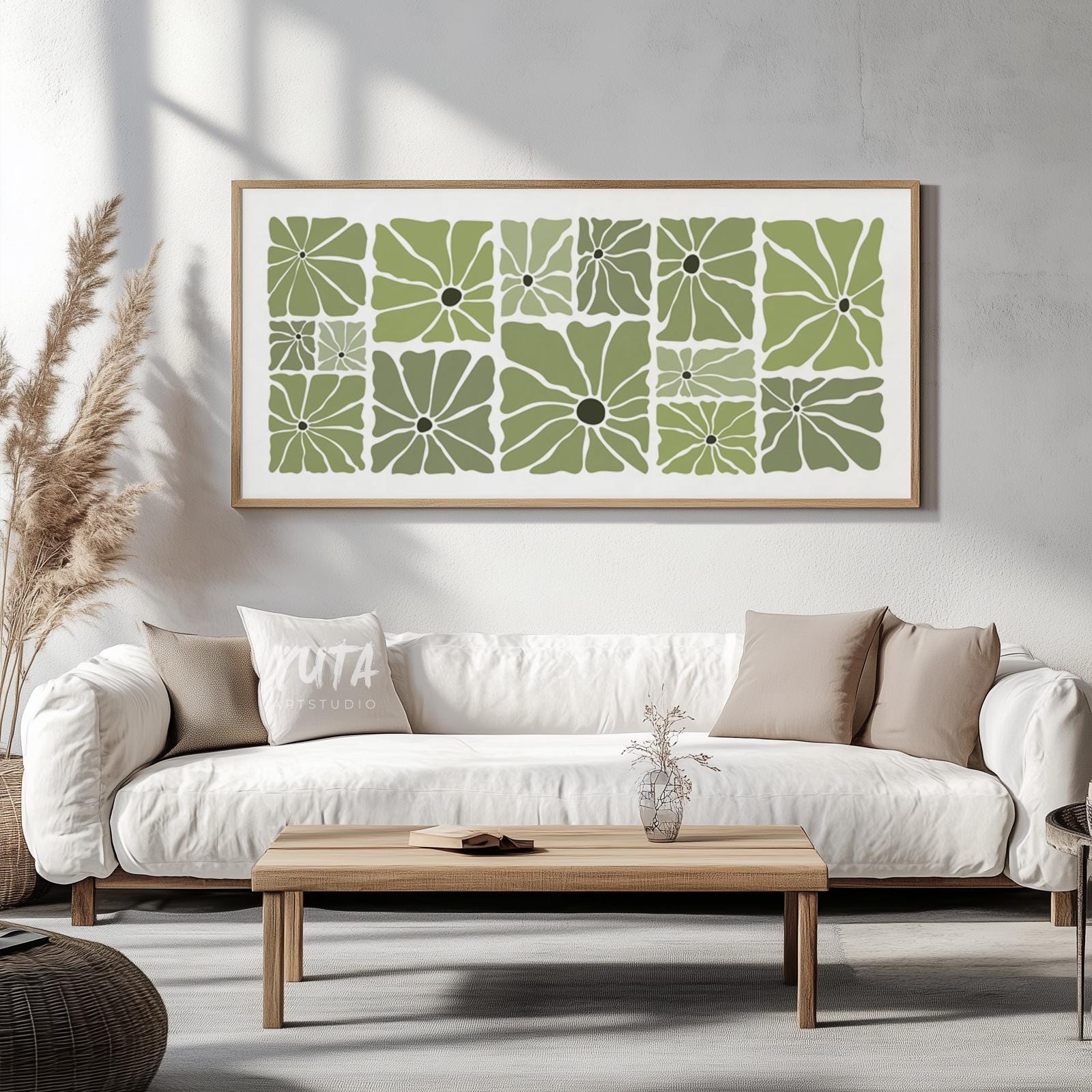 Olive green retro floral print in a natural wood frame, displayed above a white sofa.