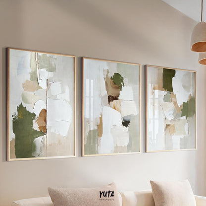 Triptych of abstract olive green and beige brushstroke paintings in light wood frames