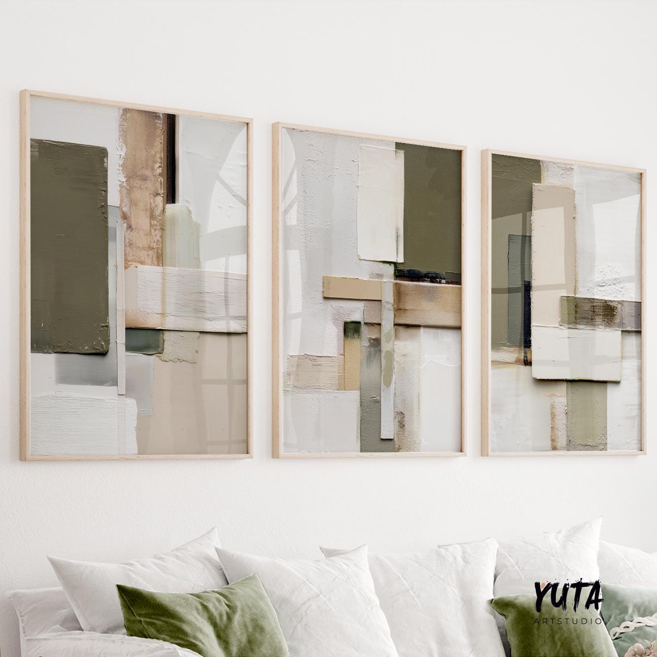 Textured olive and beige abstract triptych in light wood frames above a white sofa.