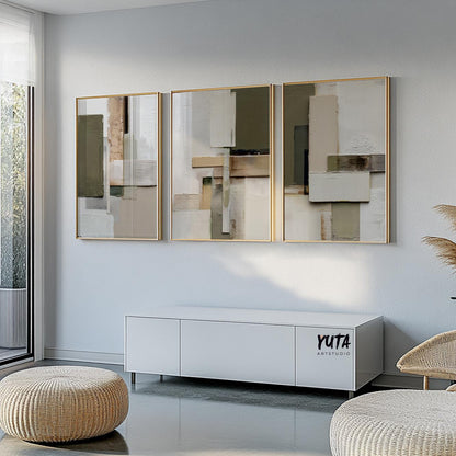 Three-panel abstract geometric artwork in gold frames above a white sideboard
