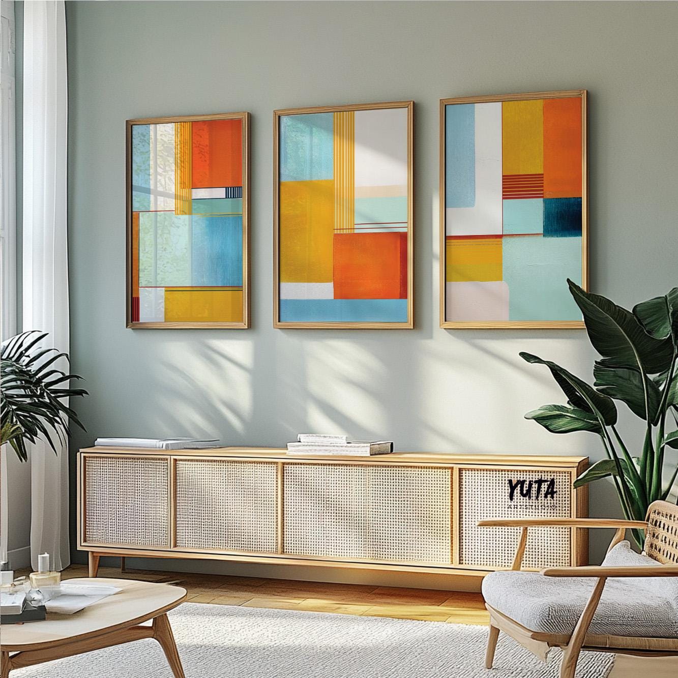 Modern abstract print with intersecting shapes in teal, yellow, blue, and warm orange tones.