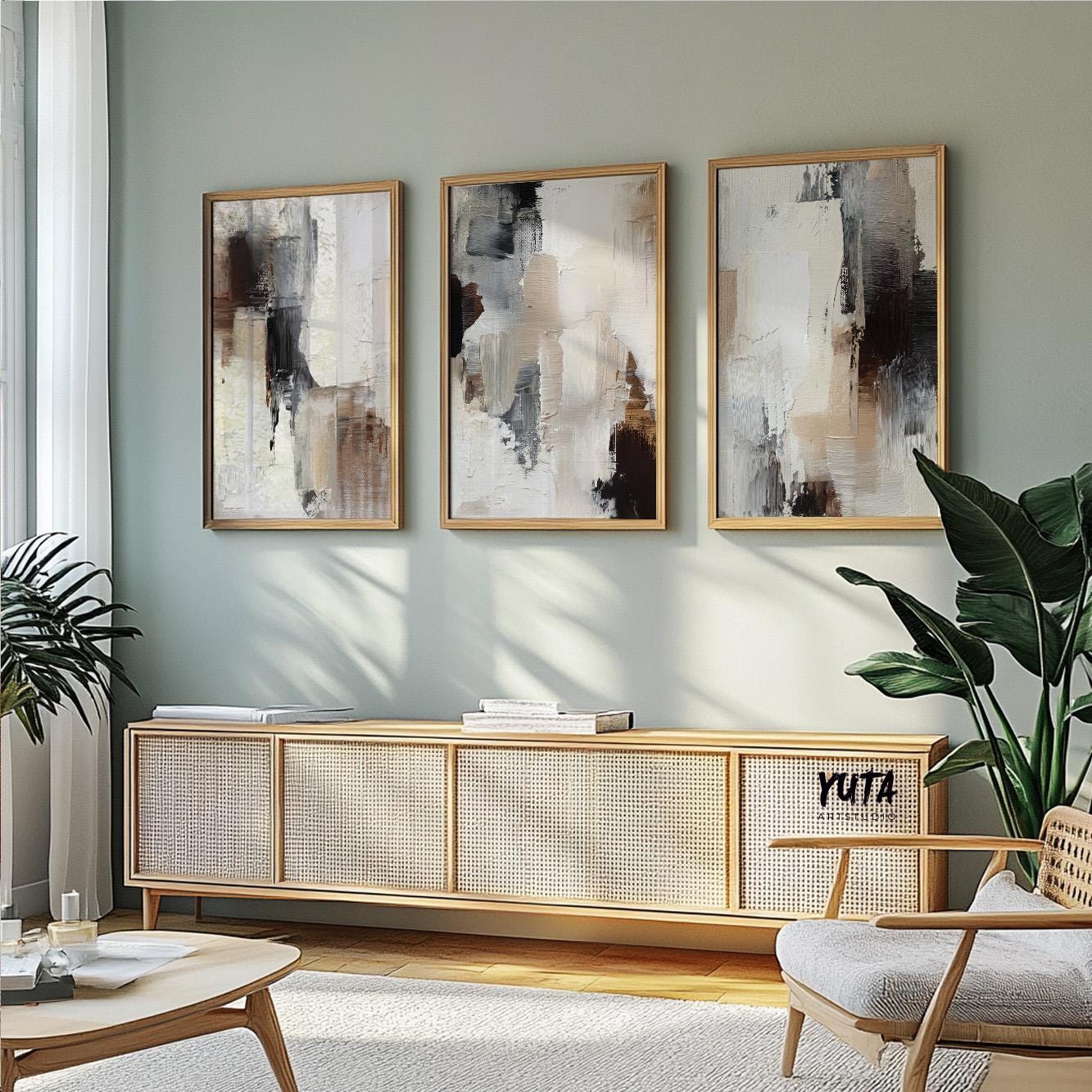 Earthy abstract painting with thick layered textures in ivory, sand, and deep charcoal shades.