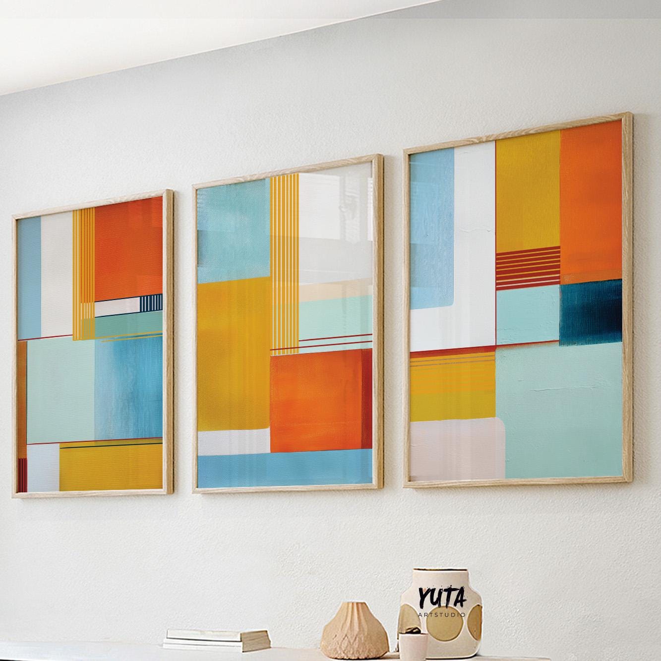 Geometric abstract artwork with bold orange, yellow, blue, and teal color blocks.
