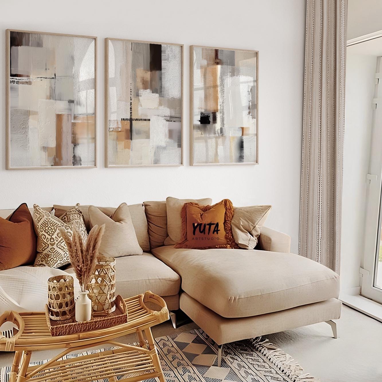 Abstract neutral artwork arranged as a framed triptych above a beige sectional sofa