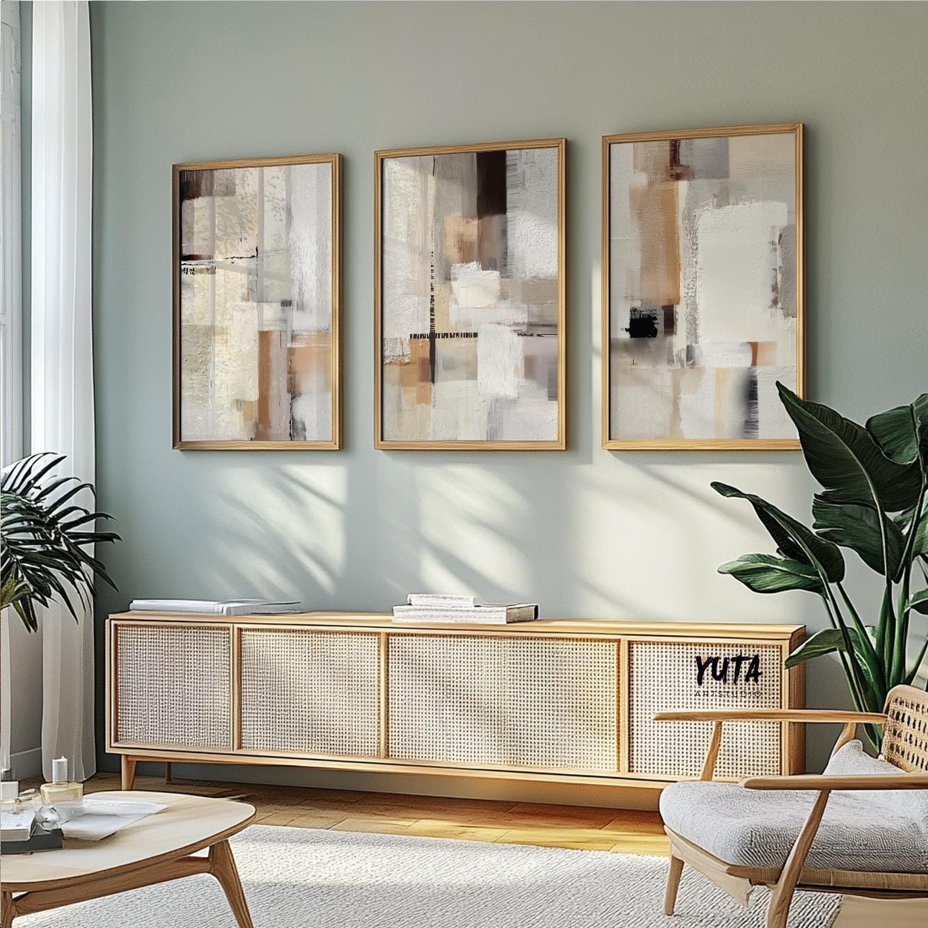 Trio of framed abstract neutral art prints arranged above a light wood sideboard.