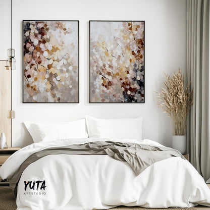 Abstract floral paintings in soft earth tones, framed as a two-piece set above a bed