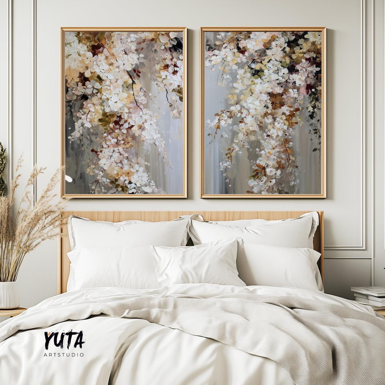 Abstract floral diptych with painterly white blossoms in light wood frames above a bed