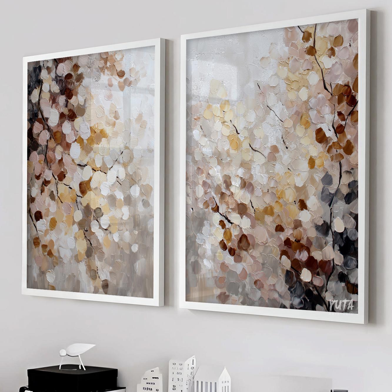 Pair of abstract nature paintings in white frames positioned above a sofa setup