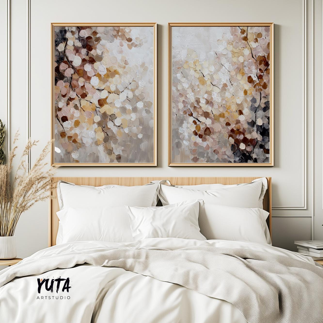 Pair of abstract botanical prints in light wood frames hung above a modern bed