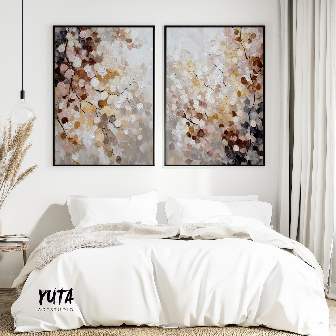 Two framed abstract botanical artworks with layered neutral blossoms above a bed