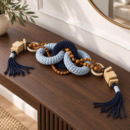 Blue decorative object with chunky woven links, wooden beads and tassels