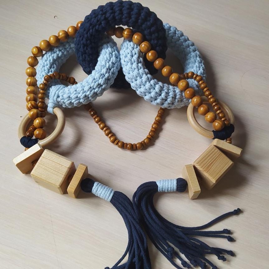 Macrame coffee table decor with light blue woven links and natural wood beads