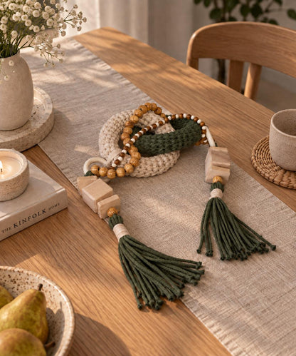 Olive green console table decor with chunky woven links and natural unfinished wood accents