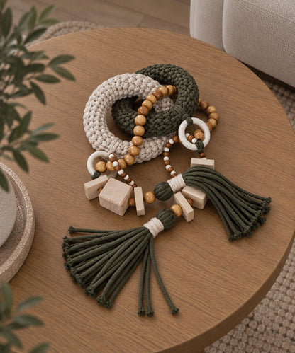 Handmade olive green coffee table decor with beige woven links, natural wood beads and tassels