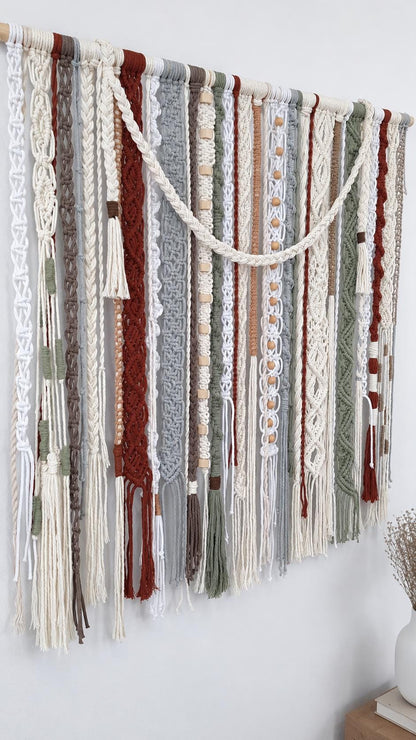 Abstract macrame wall hanging with layered woven panels beads and long fringe