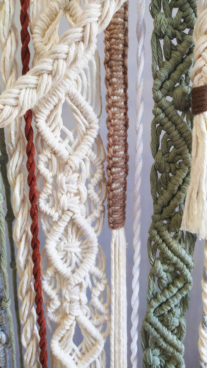 Close up of cream brown olive and gray macrame knots and woven patterns