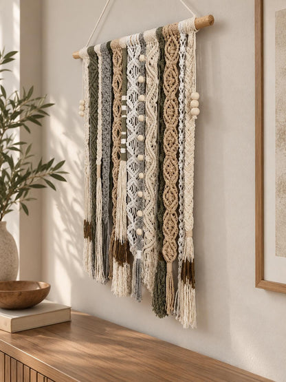 Macrame wall hanging measuring 50 by 75 cm in neutral green beige and cream colors
