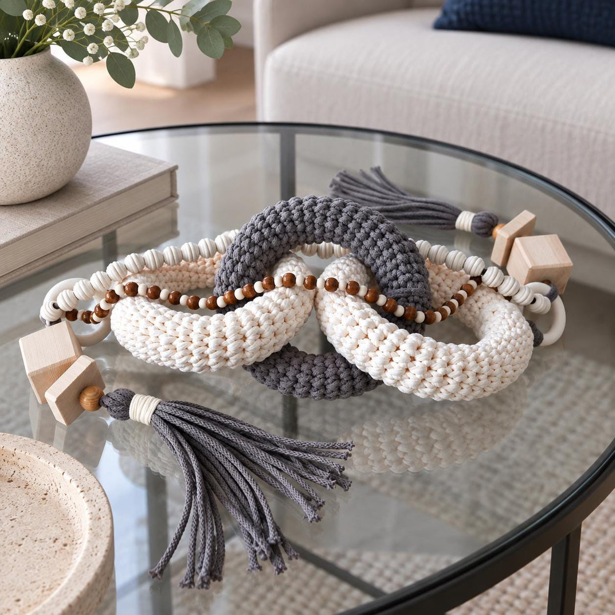 Handmade Scandinavian table decoration with gray beige woven rings, wooden beads and decorative tassels