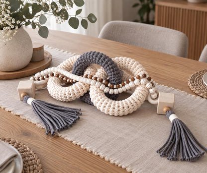 Gray and beige console table decor made from woven cotton cord, natural wood beads and three linked rings