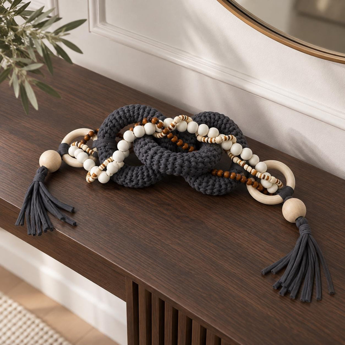 Modern table decor with gray fiber links, natural wood rings, beads and tassel details