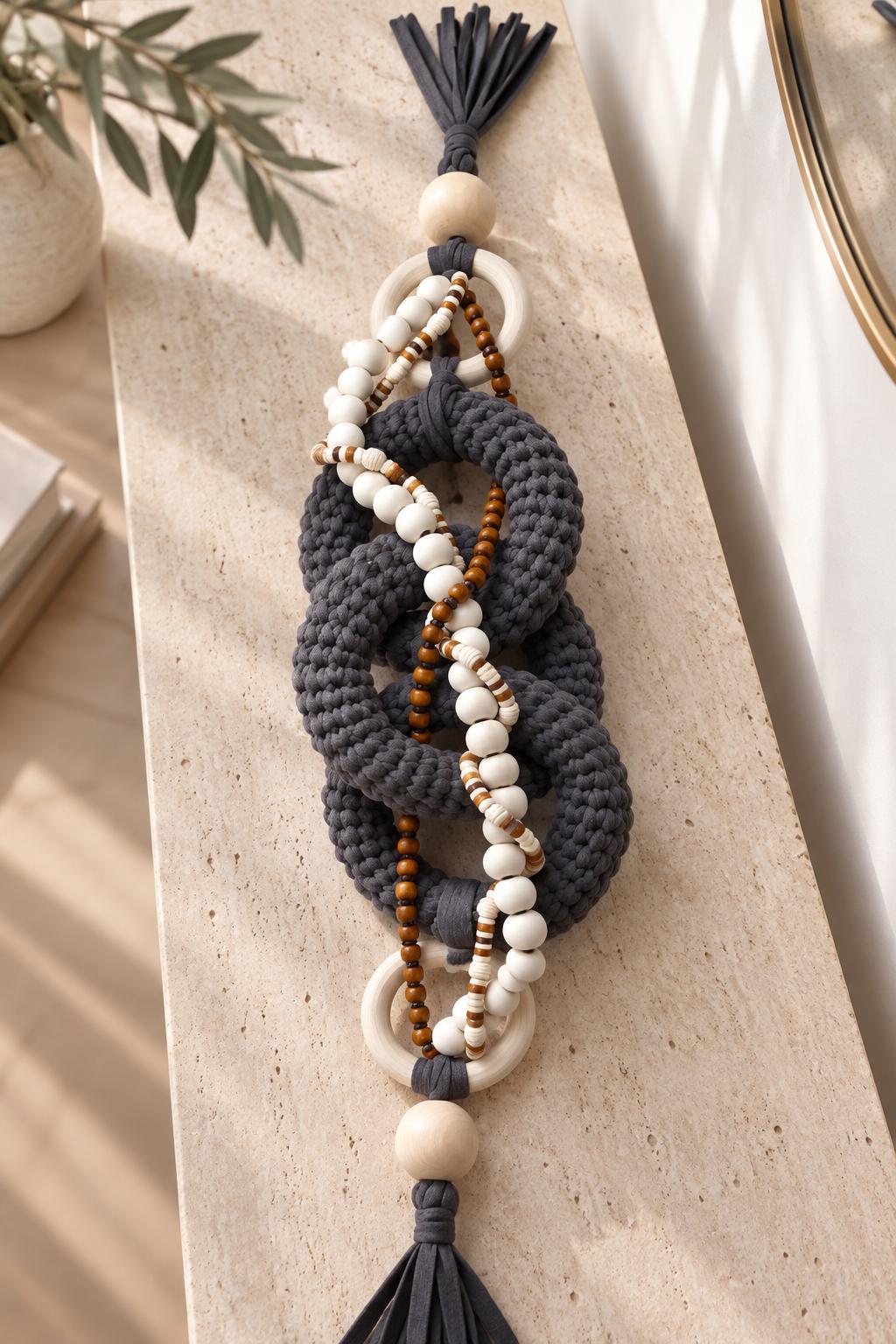 Handmade shelf decor with chunky gray fiber links, natural wooden rings and decorative beads