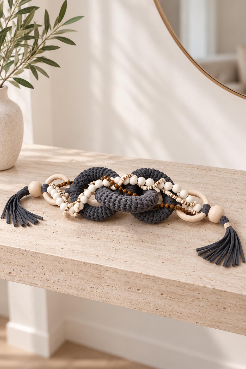 Neutral home decor chain with chunky gray links, wooden beads, rings and long tassels