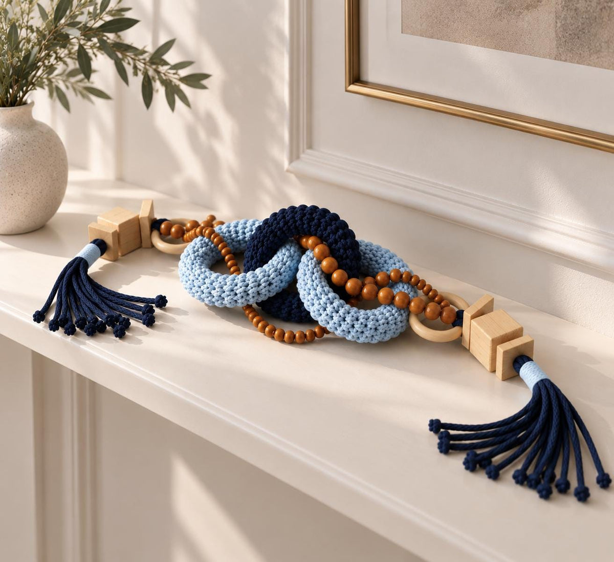 Handmade blue macrame shelf decor object with wooden beads and navy tassels