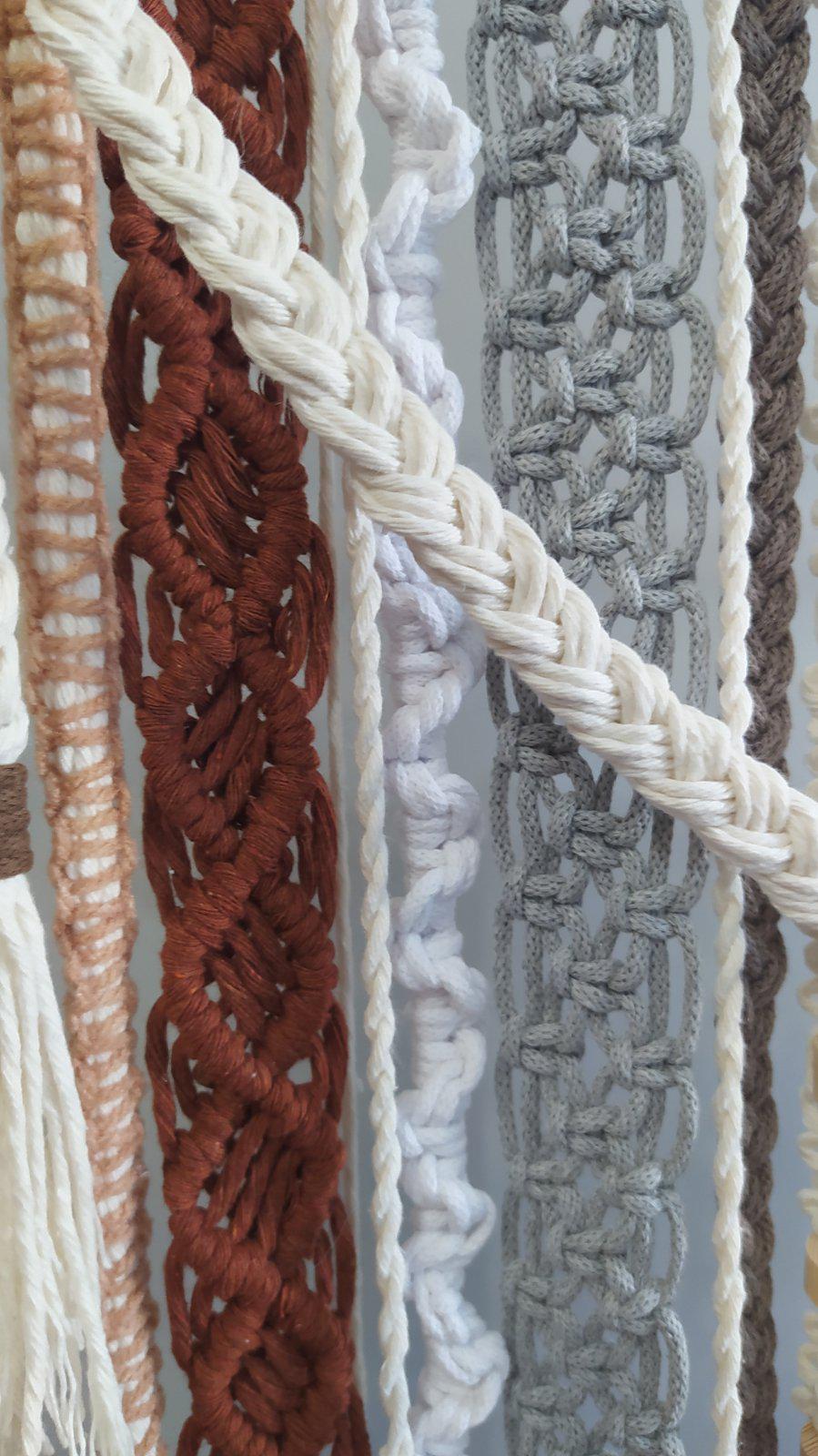 Close up of rust cream and gray woven textures on handmade macrame wall art