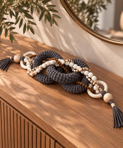 Organic modern table decor with gray textile chain, natural wood and white bead details