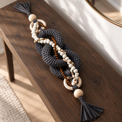 Decorative chain styled on a dark wood console in a neutral modern interior