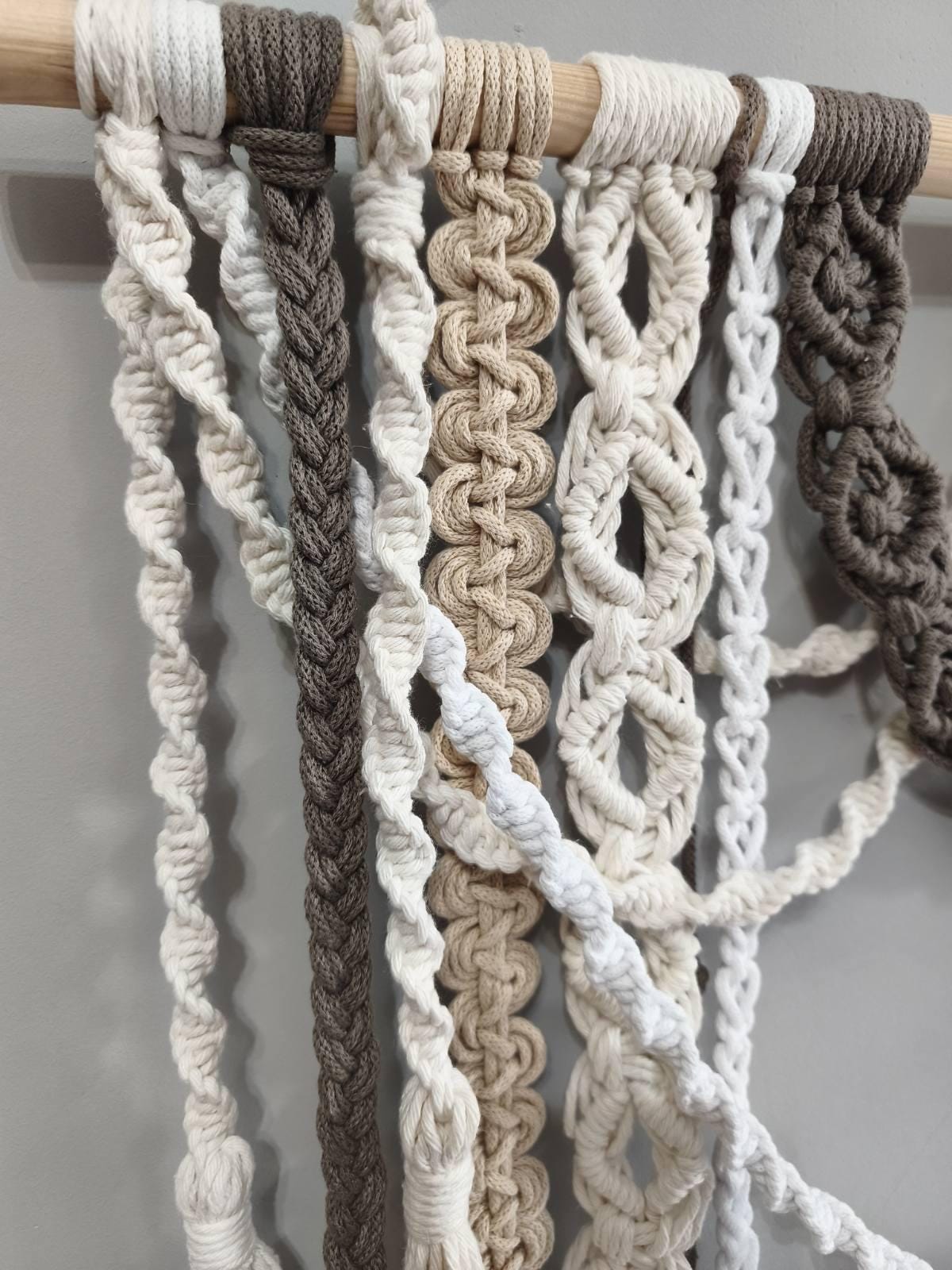 Detailed macrame knotwork with twisted cords and long cream tassels