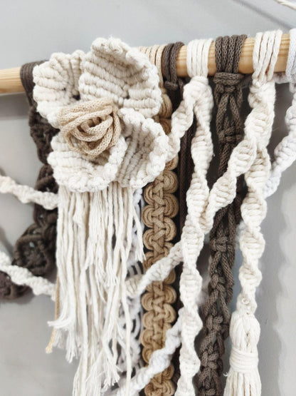 Close up of handmade three dimensional macrame flower in ivory cotton cord