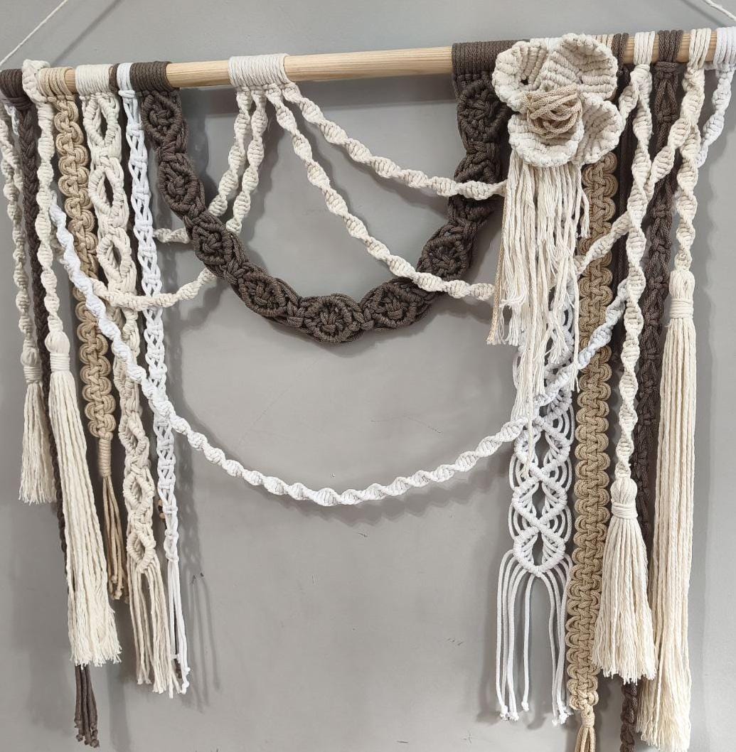 Handcrafted macrame wall hanging with ornamental knots and decorative hanging tassels