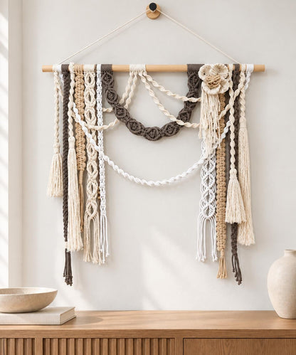 Neutral macrame wall art displayed above a console in a warm modern interior