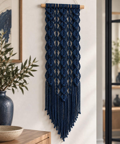 Navy blue macrame wall hanging with geometric diamond knots and long tapered fringe