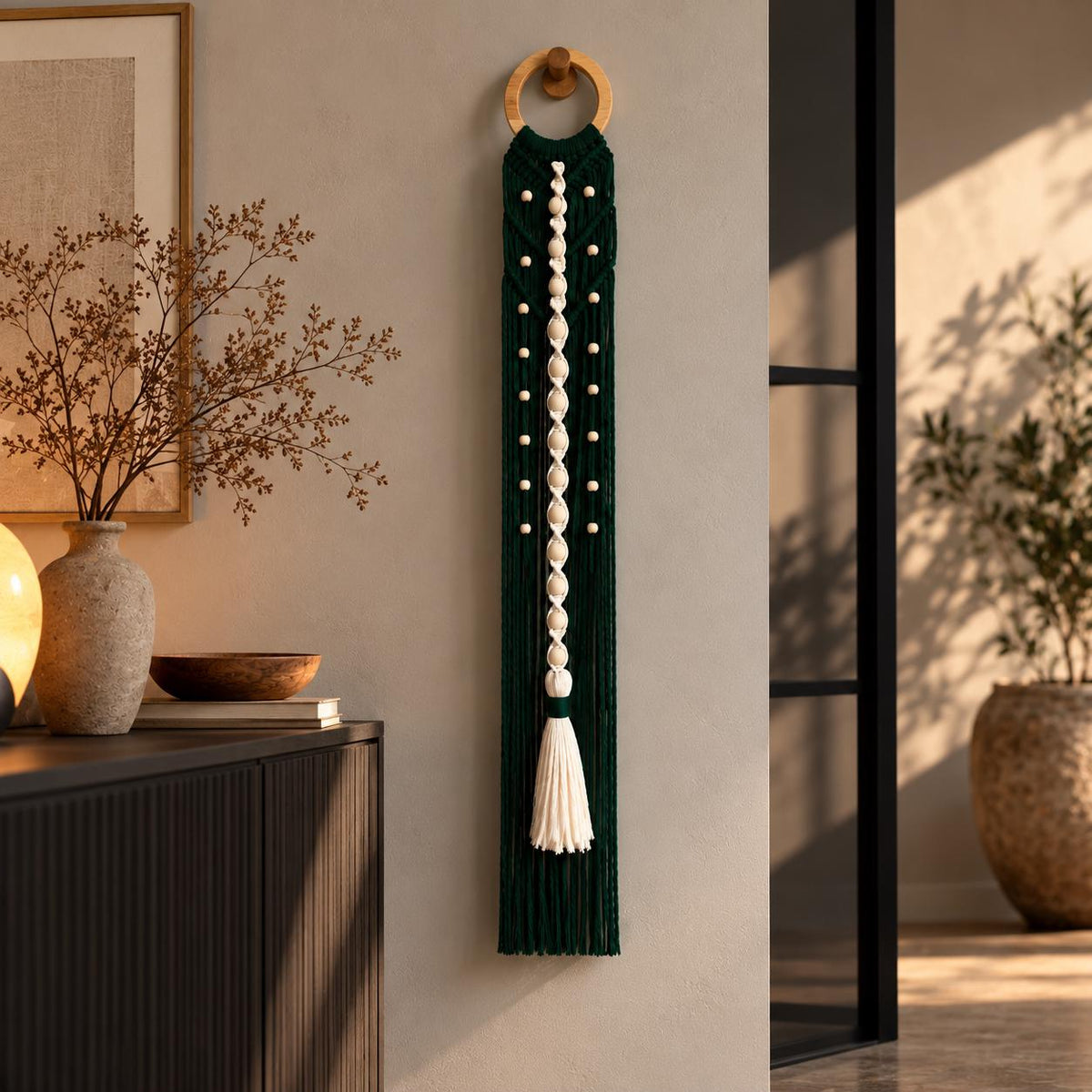Full-length bottle green macrame wall hanging featuring geometric cotton knots and long fringe