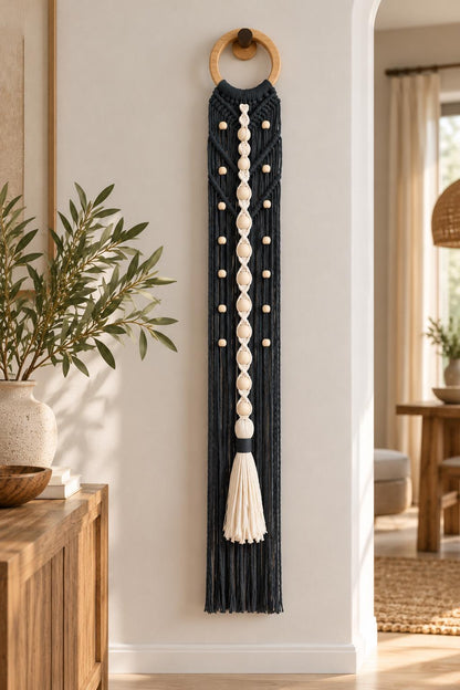 Dark charcoal cotton macrame wall hanging with geometric knots, wooden ring and ivory tassel