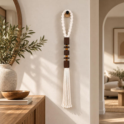 White macrame wall hanging with geometric wood details styled in a modern interior