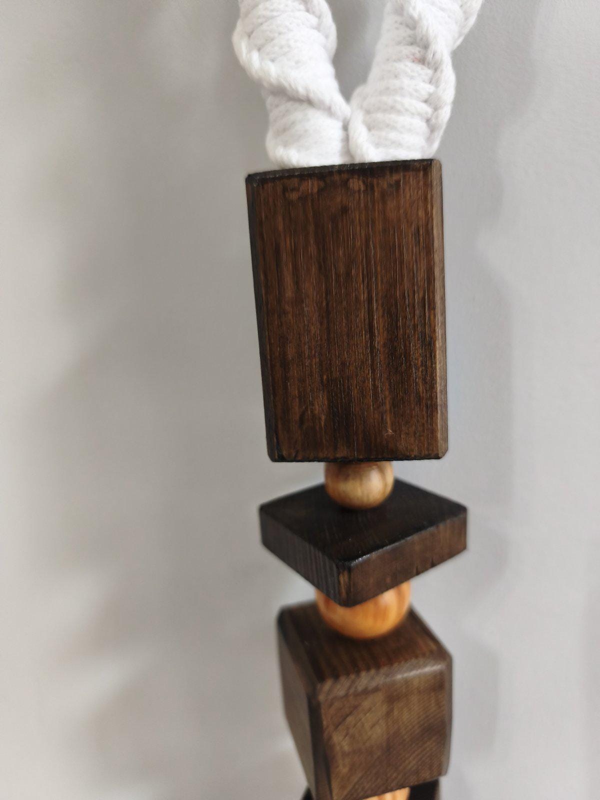 Close up of dark wooden geometric detail and white cotton cord