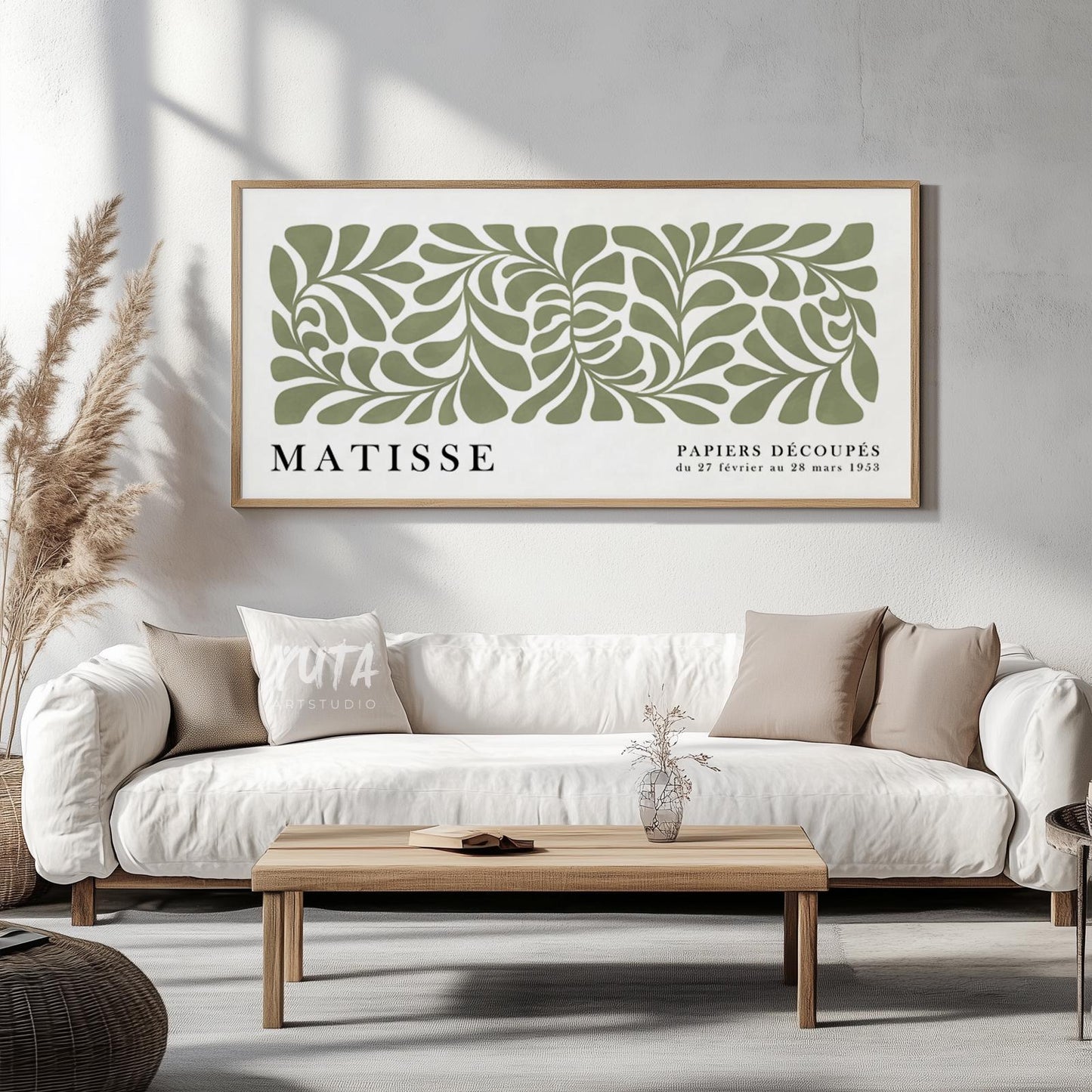 Framed sage green Matisse botanical print displayed above a sofa with pampas grass.