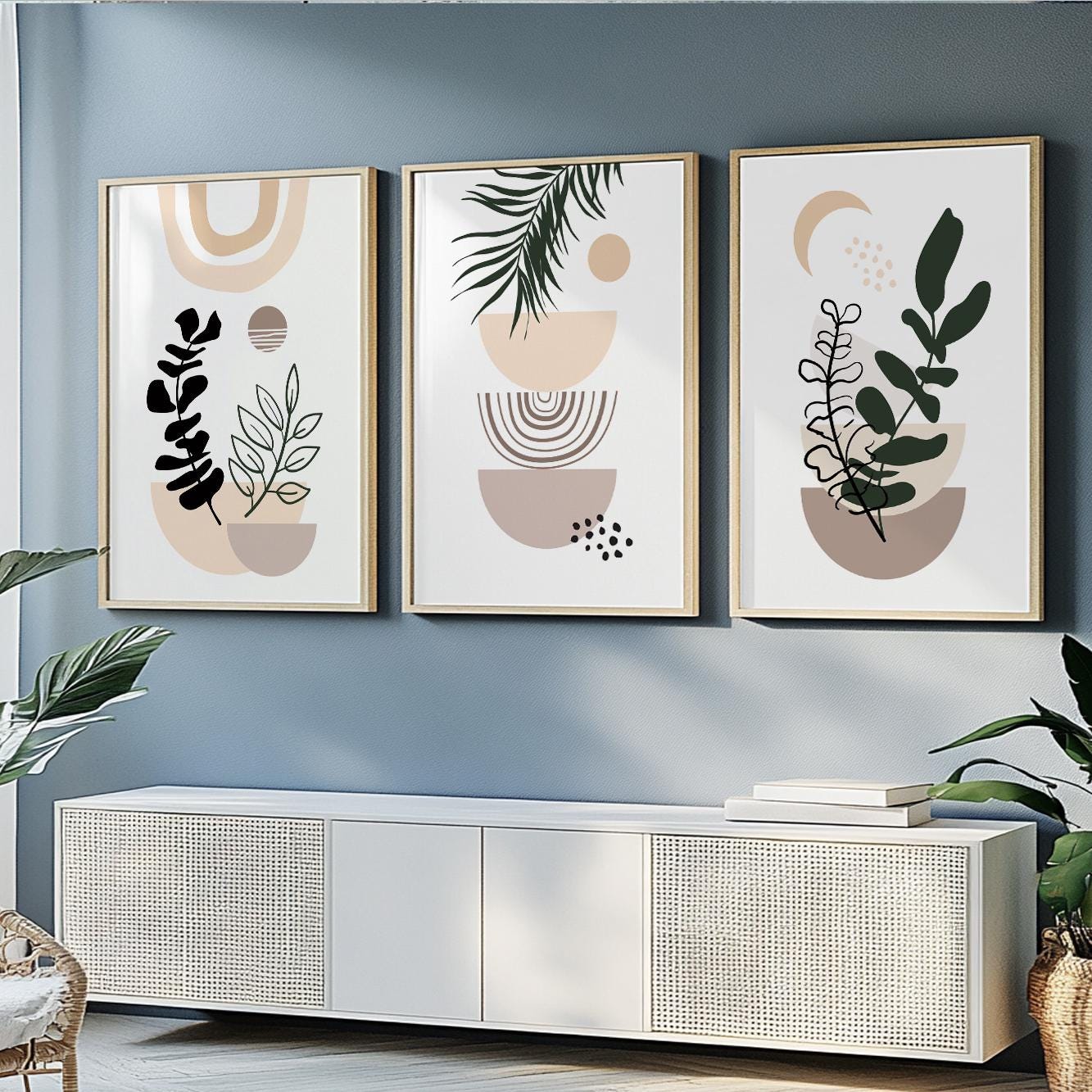 Trio of framed abstract botanical prints in light wood frames above a white console