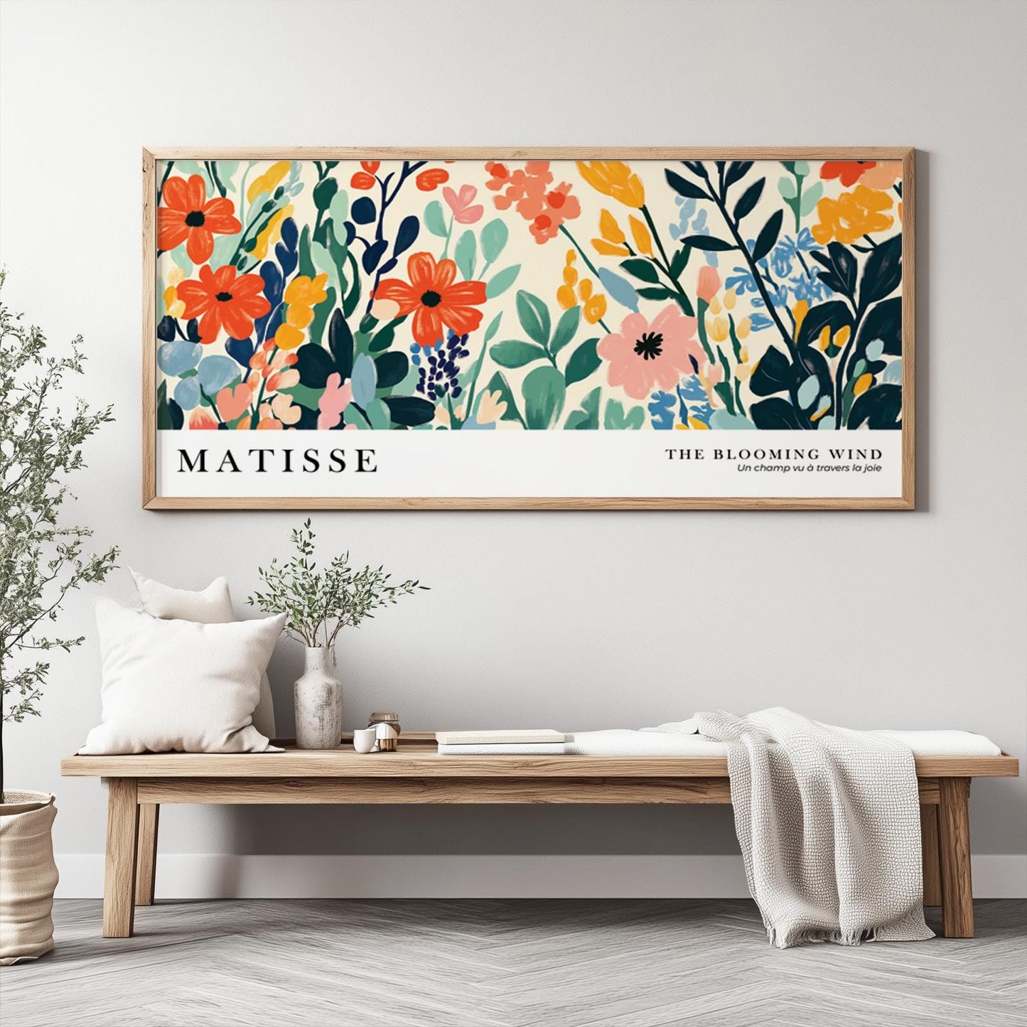 Framed abstract wildflower print in bold Matisse-inspired style above a wooden bench
