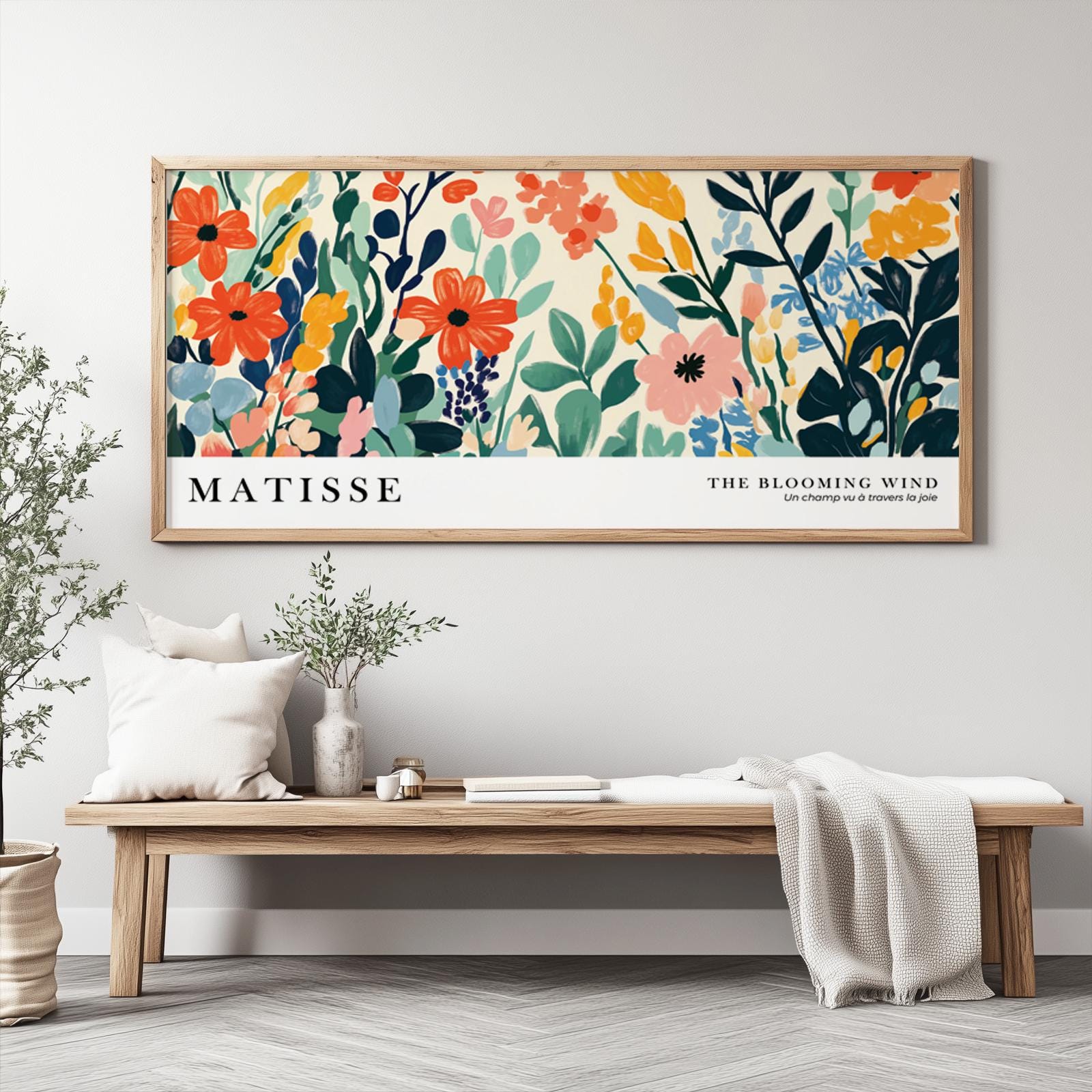 Framed abstract wildflower print in bold Matisse-inspired style above a wooden bench