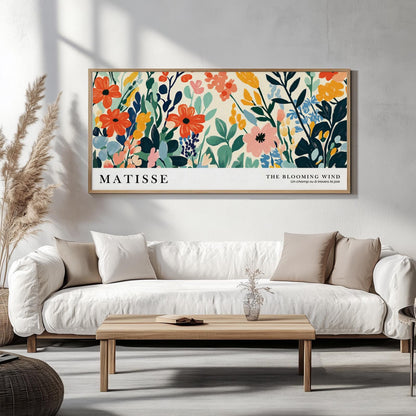 Large framed Matisse-inspired wildflower print above a white sofa in sunlit room